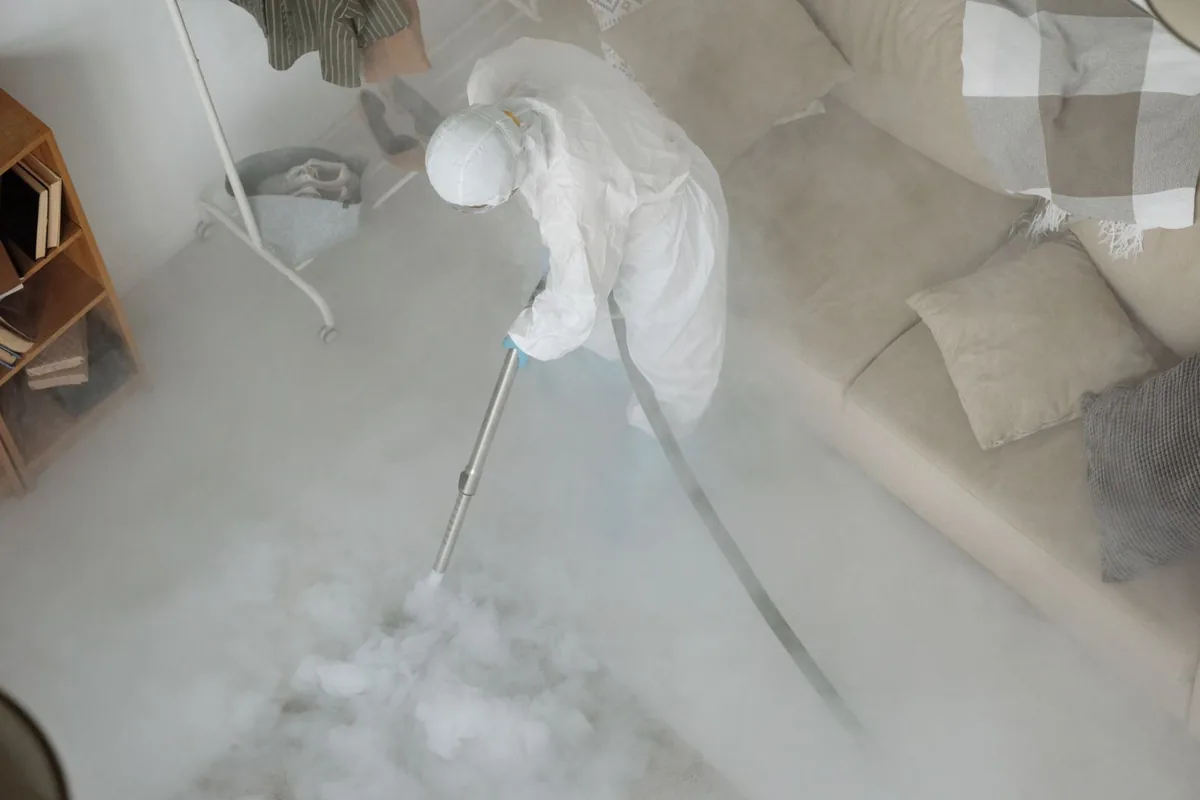 Biohazard cleanup technician in protective equipment, Strip District, Pittsburgh, PA